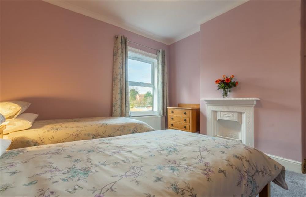 First Floor: Bedroom two with twin 3ft beds and feature Victorian fireplace at Heacham Hidey Hole, Heacham near Kings Lynn