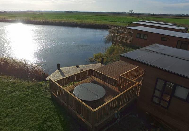 Lodges looking out over the lake at Head Fen Country Retreat in Ely, Cambridge