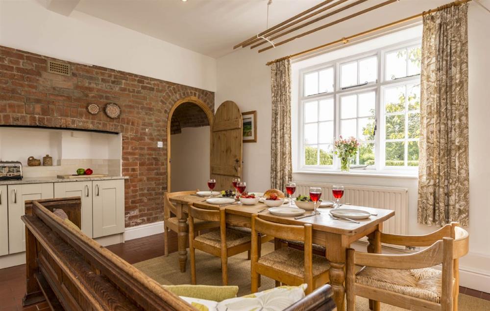 Fully equipped farmhouse kitchen with dining table and door leading to the sitting room at Hearn Lodge, Bishops Lydeard