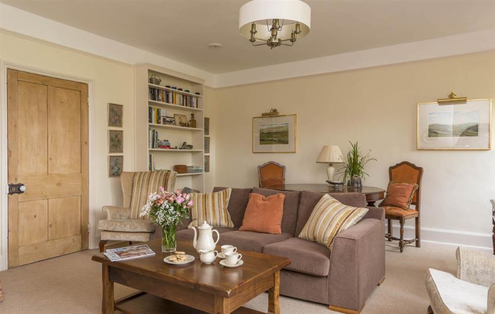 Spacious sitting room with wood burning stove and dining table (photo 3) at Hearn Lodge, Bishops Lydeard