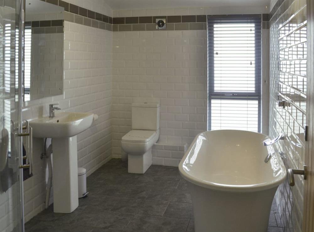 Bathroom with bath, shower cubicle and heated towel rail at Heartwell Cottage in Wolsingham, near Stanhope, County DurhamCounty Durham, England