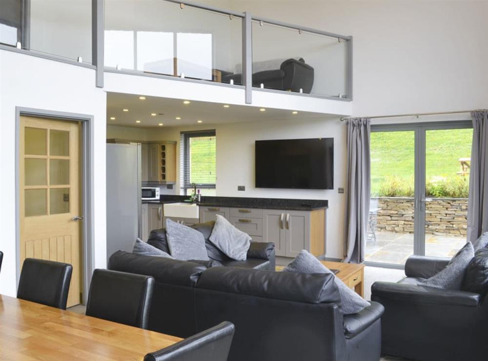 Stylish open plan living space with wood burner and 65” Freeview TV at Heartwell Cottage in Wolsingham, near Stanhope, County DurhamCounty Durham, England