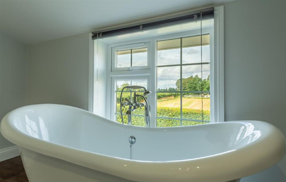 Freestanding bath with view overlooking the fields at Heath Cottage, Mattishall