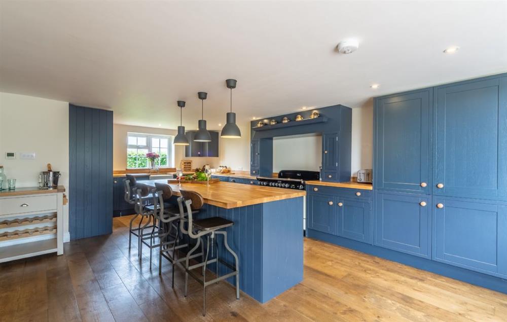Large and fully equipped kitchen with bar stools at Heath Cottage, Mattishall