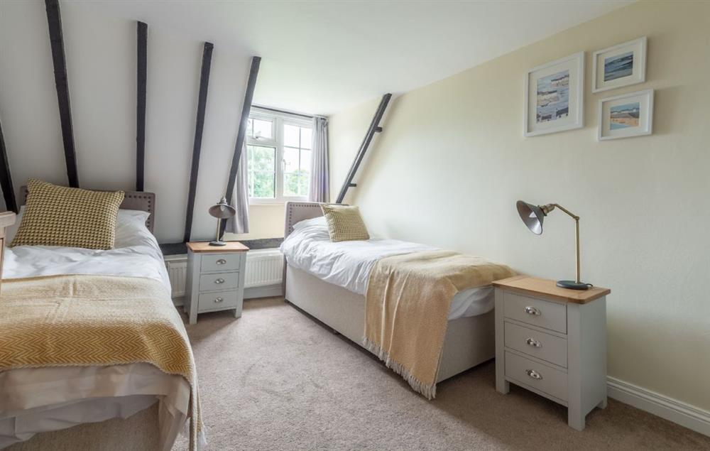 Twin bedroom with zip and link beds which can be converted into a king size bed on request at Heath Cottage, Mattishall