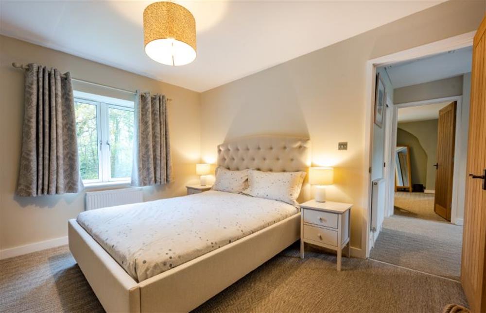 First floor: Bedroom two with a king-size bed at Heathcot, High Kelling near Holt
