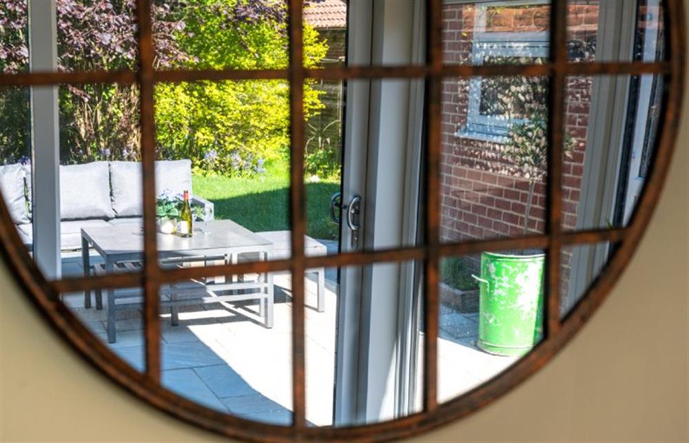 Ground floor: Reflection of the outdoor entertainment area from the sitting room at Heathcot, High Kelling near Holt