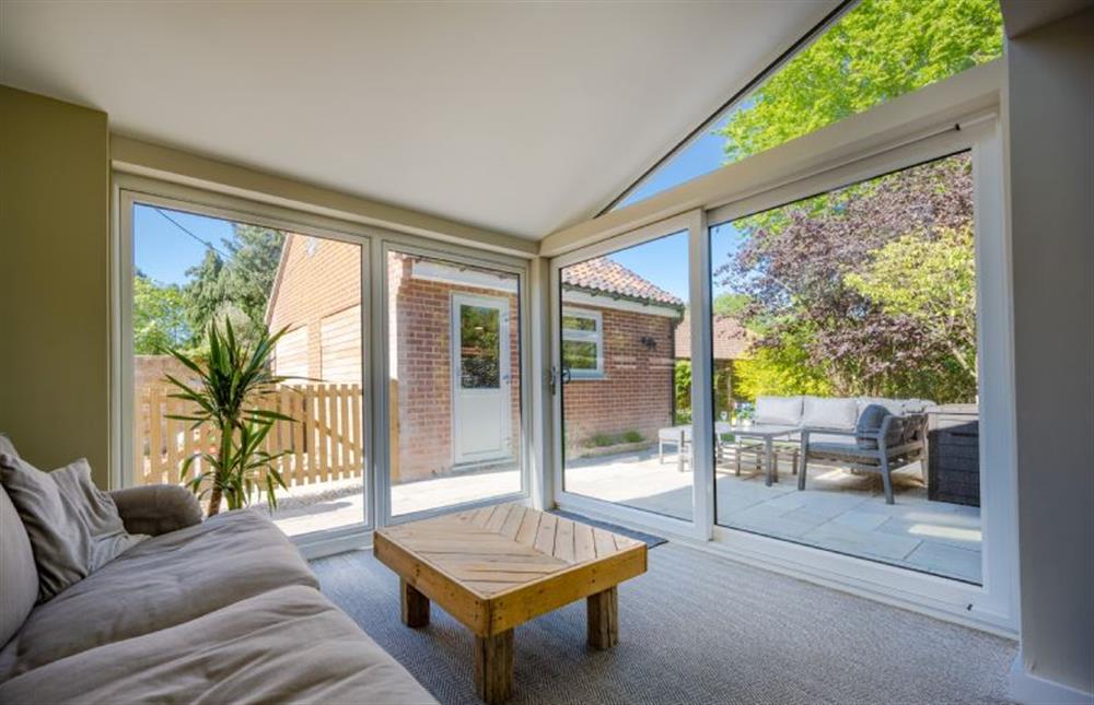 Ground floor: Sitting room with doors onto the terrace and outdoor entertainment area
