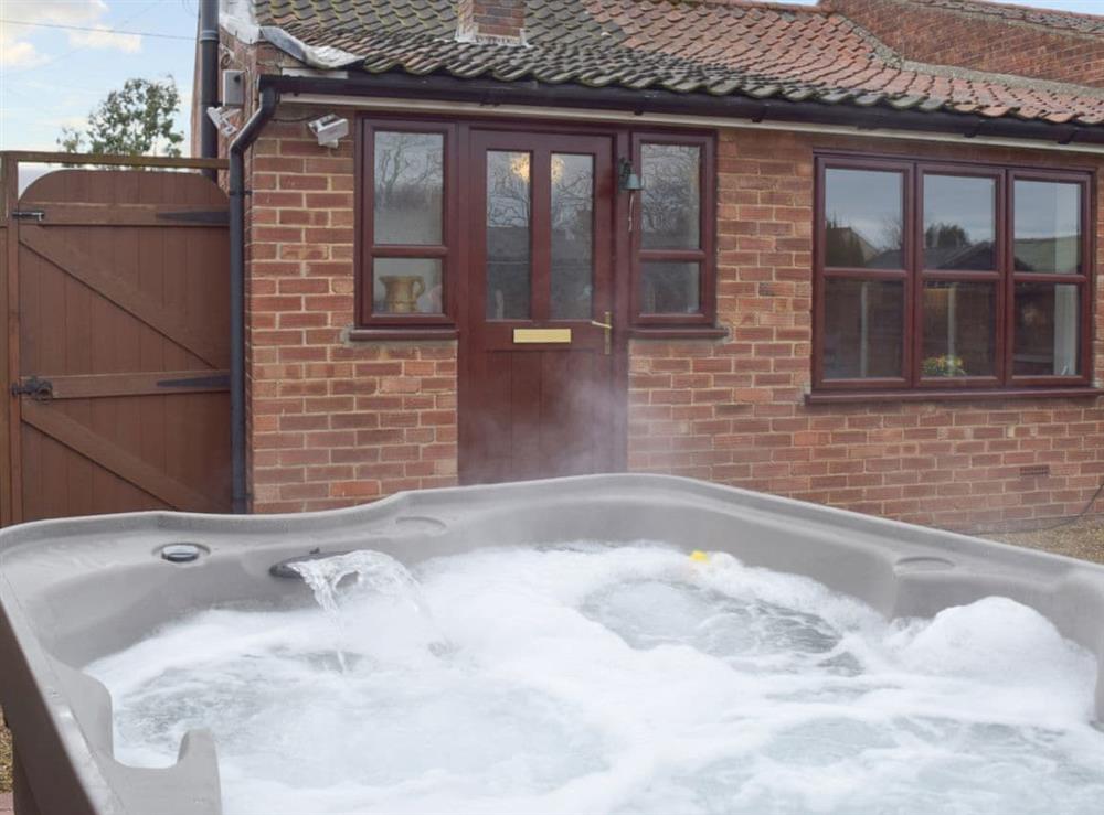 Relax in the private hot tub at Heathcote Cottage in Hickling, near Wroxham, Norfolk