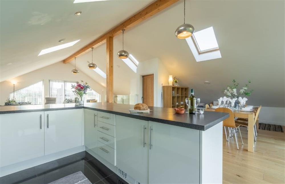 Open plan kitchen with oven, hob, dishwasher, fridge and microwave at Heatherbank, St Agnes