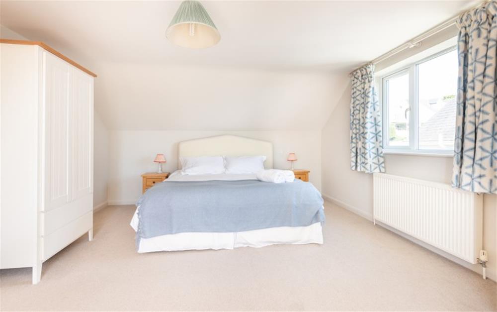 The master bedroom with adjoining bathroom and balcony at Heatherdale in Salcombe