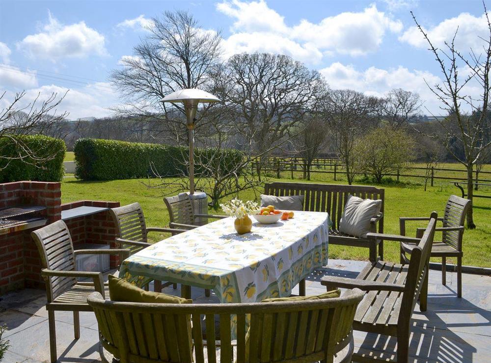Outdoor dining area with BBQ at Heathfield Down Farmhouse in Modbury, S. Devon., Great Britain