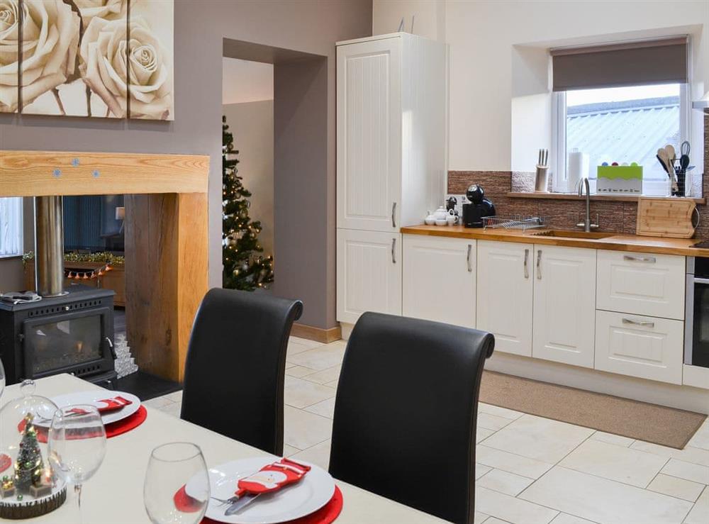 Elegant dining area and practically located kitchen at Heckley Stable Cottage, 