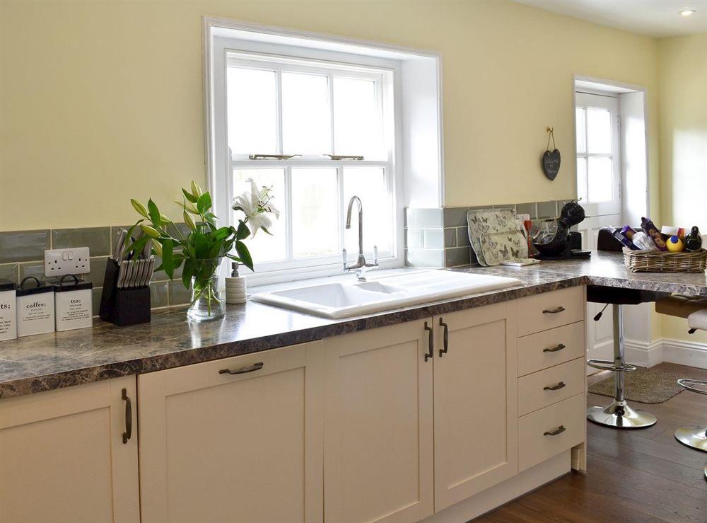 Spacious kitchen with breakfast bar area at Helena in Whitby, North Yorkshire