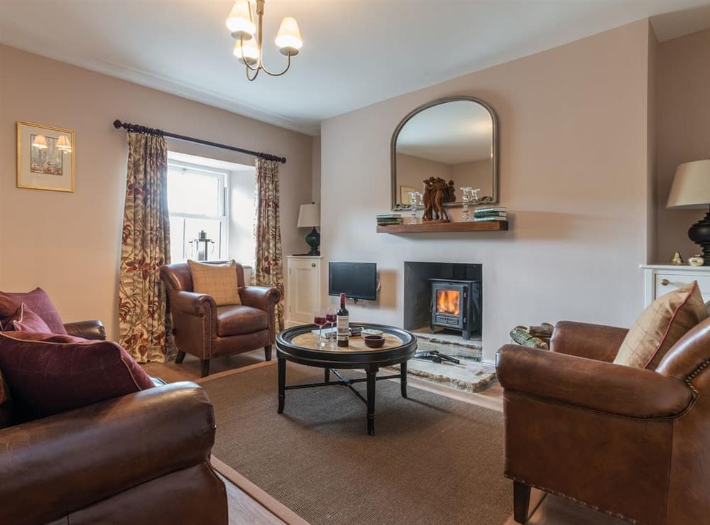 Cosy living room with wood burner at Helwith Cottage in Helwith, near Marske, Yorkshire, North Yorkshire