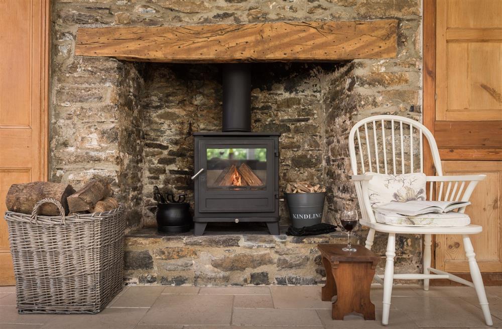 A stone fireplace with a log burner