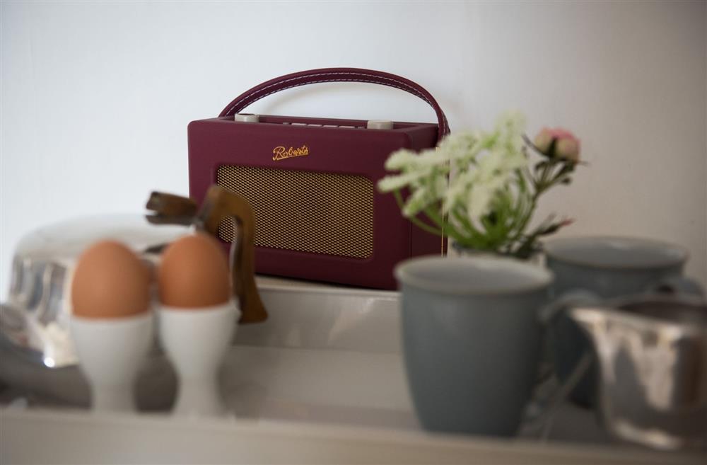 The kitcehn counter with a radio, boiled eggs and mugs