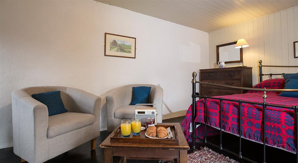The double bedroom accessed by an external stone staircase at Hen Dy in Beddgelert, Gwynedd