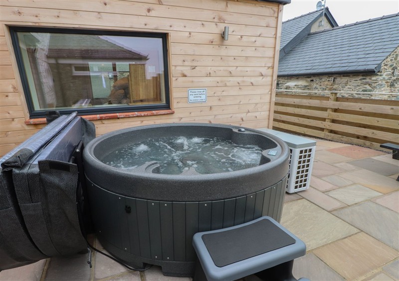 Relax in the hot tub at Hen Penmynydd, Llanfwrog near Llanfachraeth
