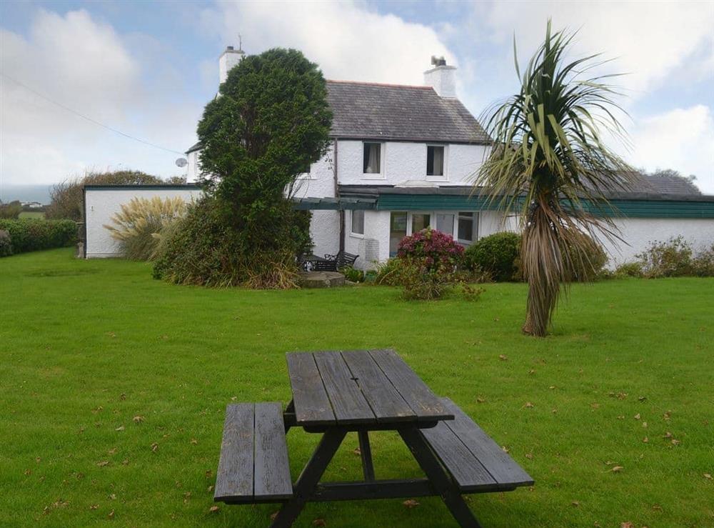 Large lawned garden with picnic style seating at Hen Ysgol in Llanfaethlu, Anglesey., Gwynedd