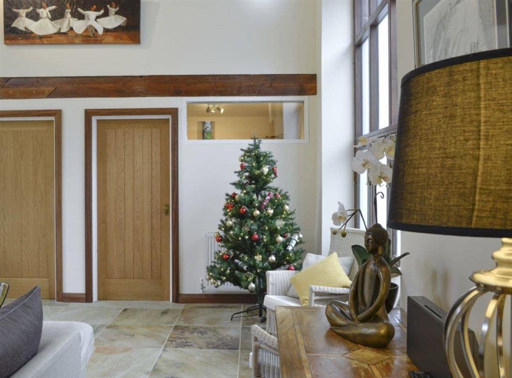 Traditional,seasonally decorated tree within the living room during the festive period at Hendre Barn Mawr in Abergynolwyn, Gwynedd