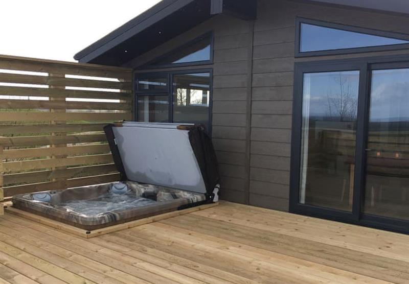 Hot tub and the decked area in the Otters View Lodge at Henfields Country Retreat in Cannington, South West