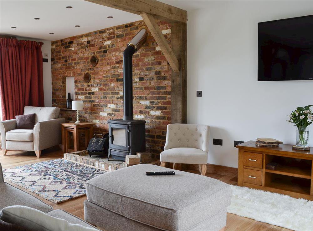 Living space with wood burner & exposed brick at Henry Oscar House in Winchelsea, near Rye, Sussex, East Sussex