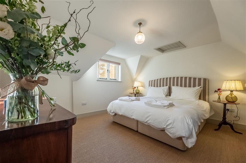 Bedroom one with 6’ super-king size bed and en-suite shower room at Hensill Farmhouse, Hawkhurst
