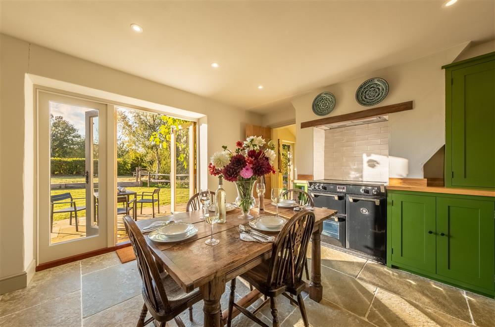 Kitchen with range cooker and french doors to garden at Hensill Farmhouse, Hawkhurst
