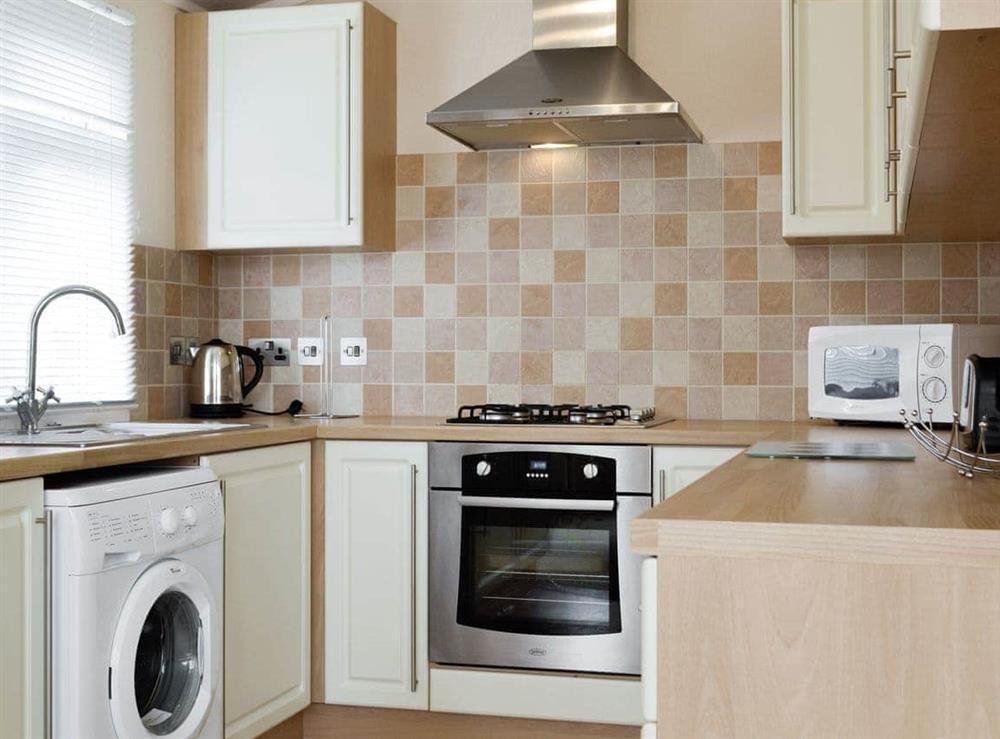 Well-equipped fitted kitchen at Heron Lodge in Hopton-on-Sea, Great Yarmouth, Norfolk