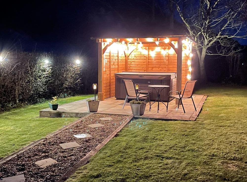 Garden at night with covered hot tub at Herrock View in Knill, near Presteigne, Herefordshire