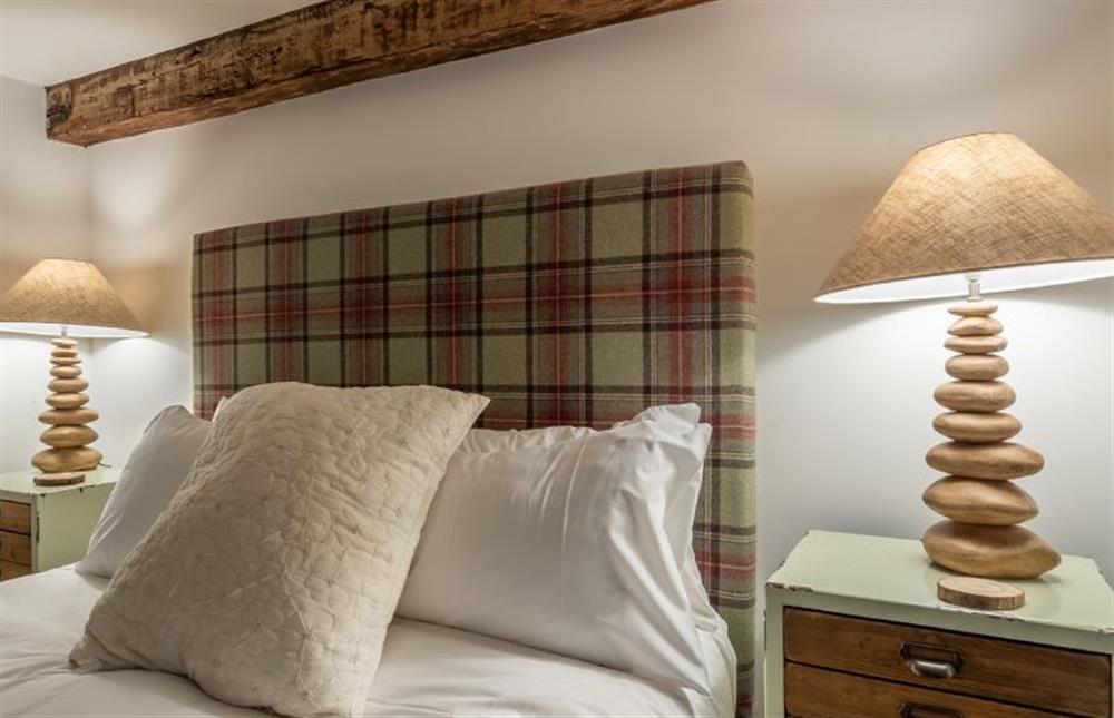First floor: Bedroom two, with king-size bed at Hideaway Barn, Thornham near Hunstanton