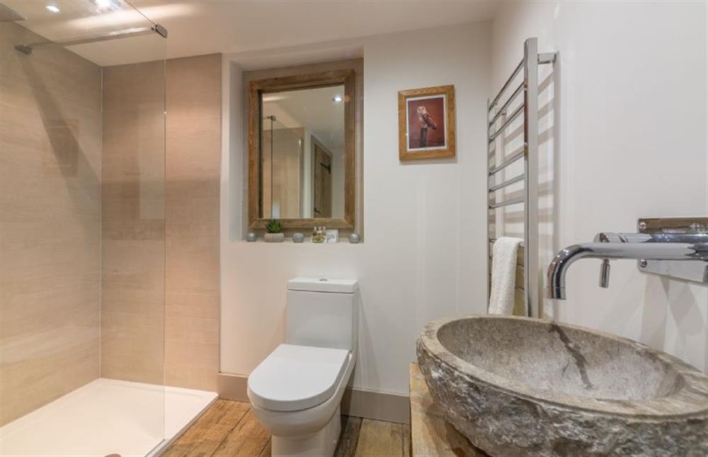 First floor: Shower room with polished stone wash basin at Hideaway Barn, Thornham near Hunstanton