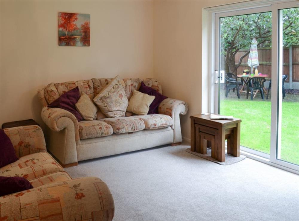 Living room with sliding patio doors leading to garden (photo 2) at Hideaway Cottage in Kingsgate, near Broadstairs, Kent