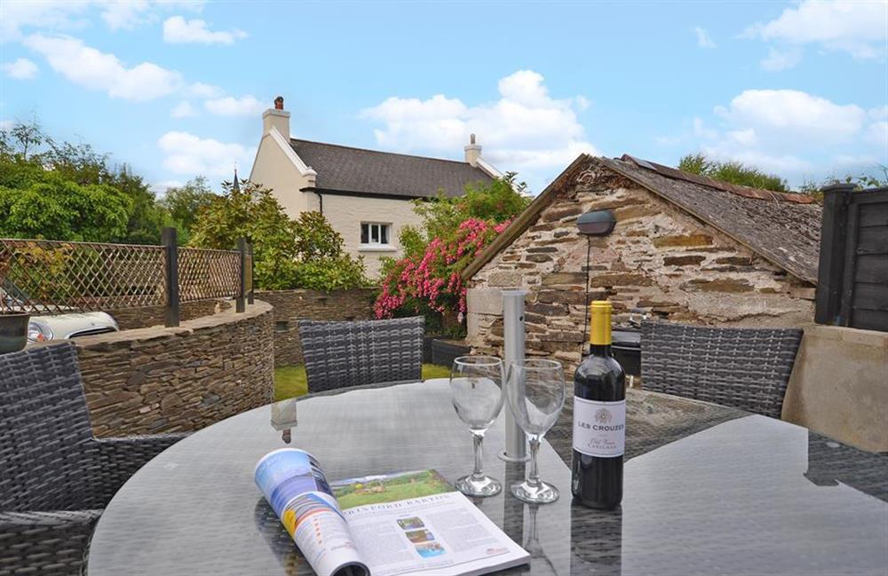 The terrace is furnished with lovely table and chairs at Hideaway, Harbertonford