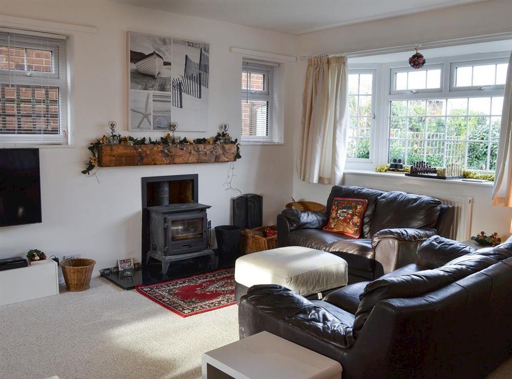 Cosy living room with wood burner at Hideaway in Whitstable, Kent