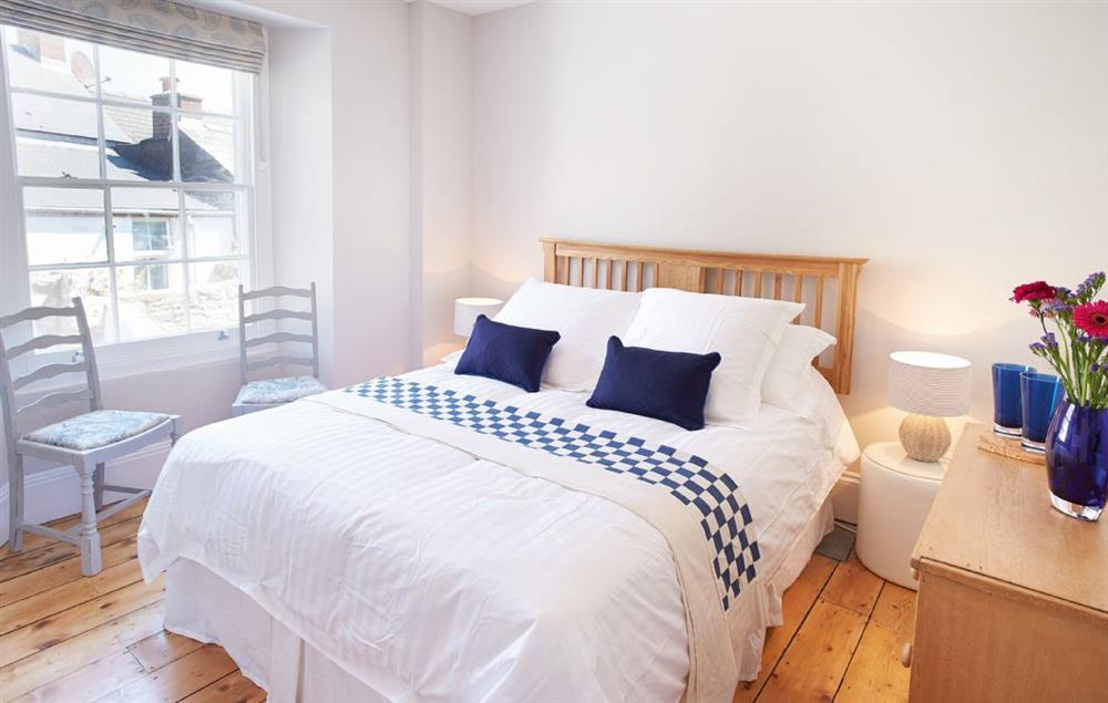 Bedroom on the first floor with a 5’ king-size bed at High House (Sleeping 10), Tenby