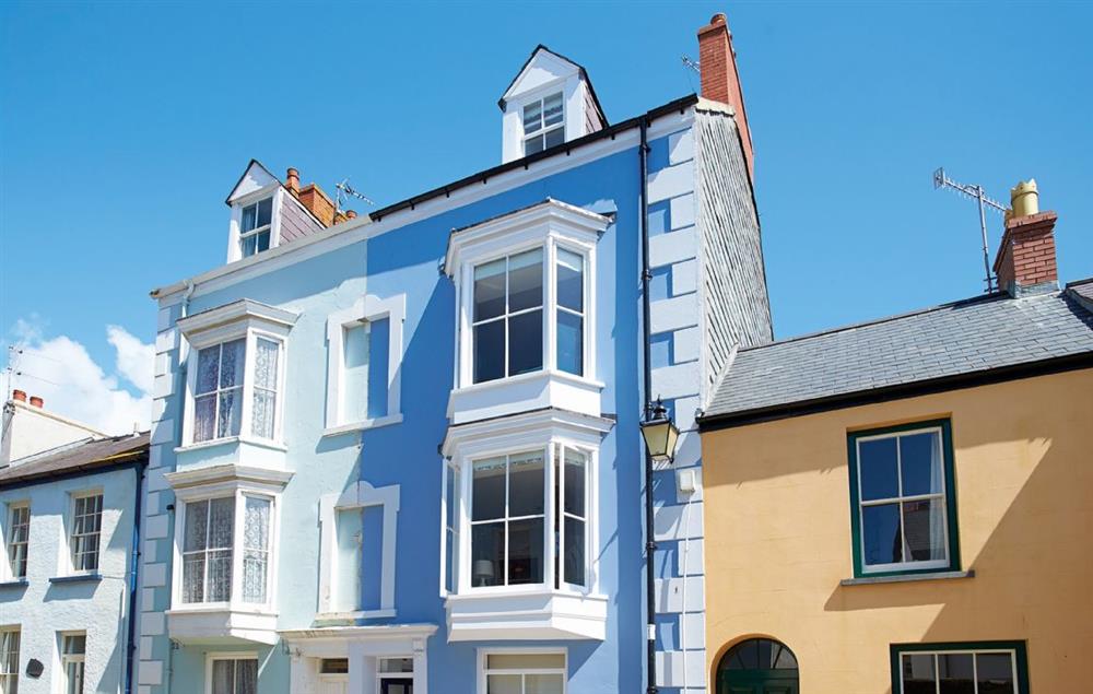 High House is the handsome, cornflower blue property with the dark front door at High House (Sleeping 10), Tenby