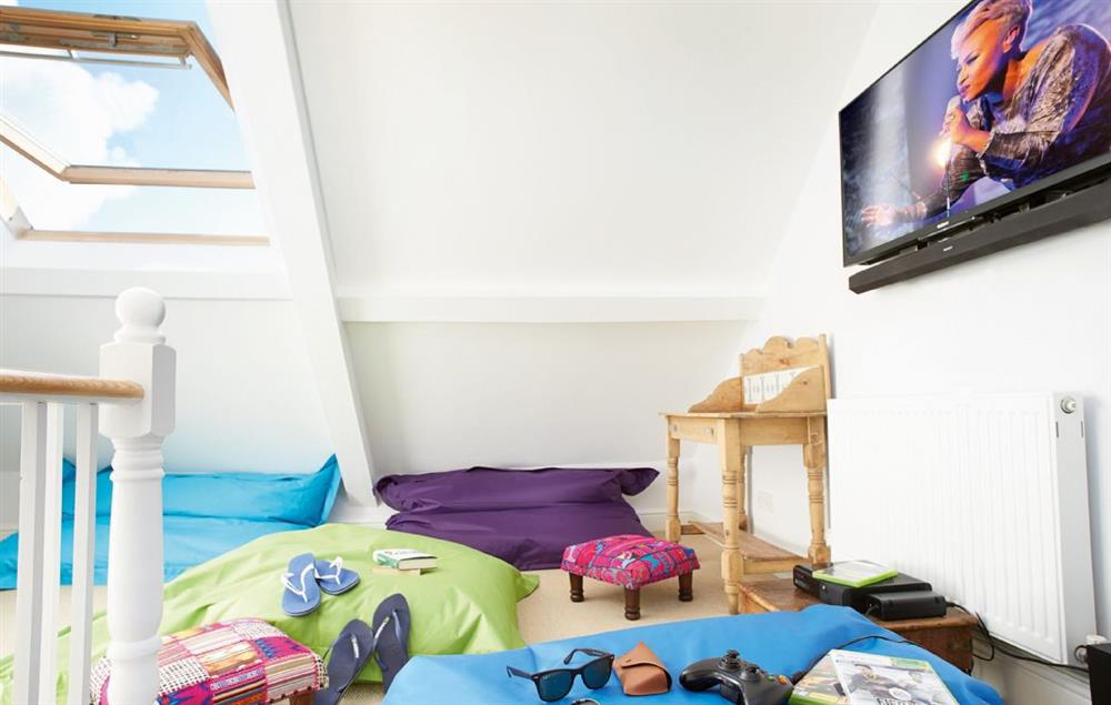 Attic chill out room with Smart television, an X-box 360 games console, bluetooth connected Bose sound box, board games and beach games