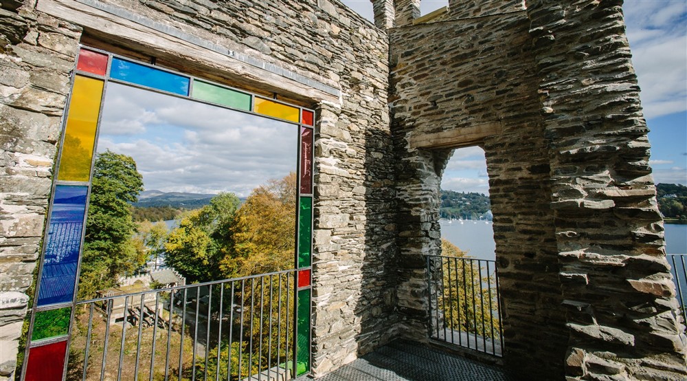 North side of Claife Viewing Station with coloured glass in the windows and views north and east across Windermere, Lake District at High Strawberry Gardens in Near Hawkshead, Cumbria
