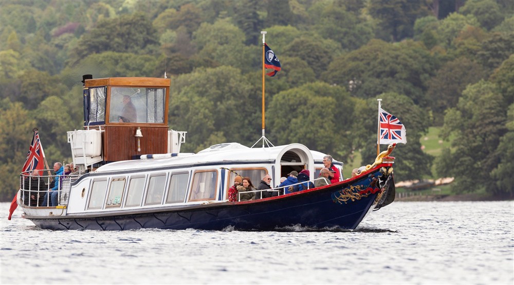 Passengers enjoying a trip on the Steam Yacht Gondola, Coniston, Lake District at High Strawberry Gardens in Near Hawkshead, Cumbria