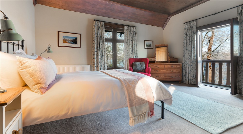 The double bedroom with balcony overlooking Lake Windermere at High Strawberry Gardens in Near Hawkshead, Cumbria