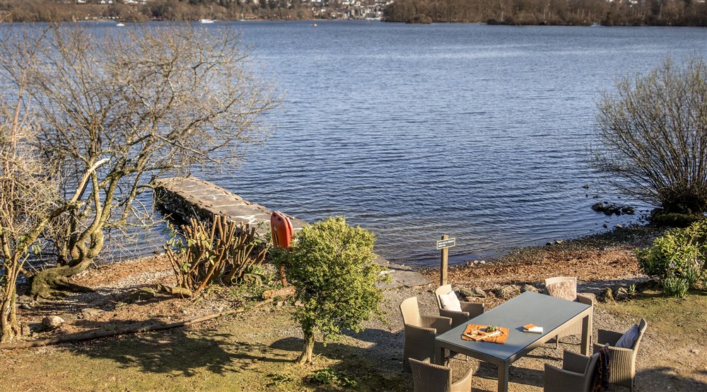 The garden and lake, viewed from the balcony, at High Strawberry Gardens in Near Hawkshead, Cumbria