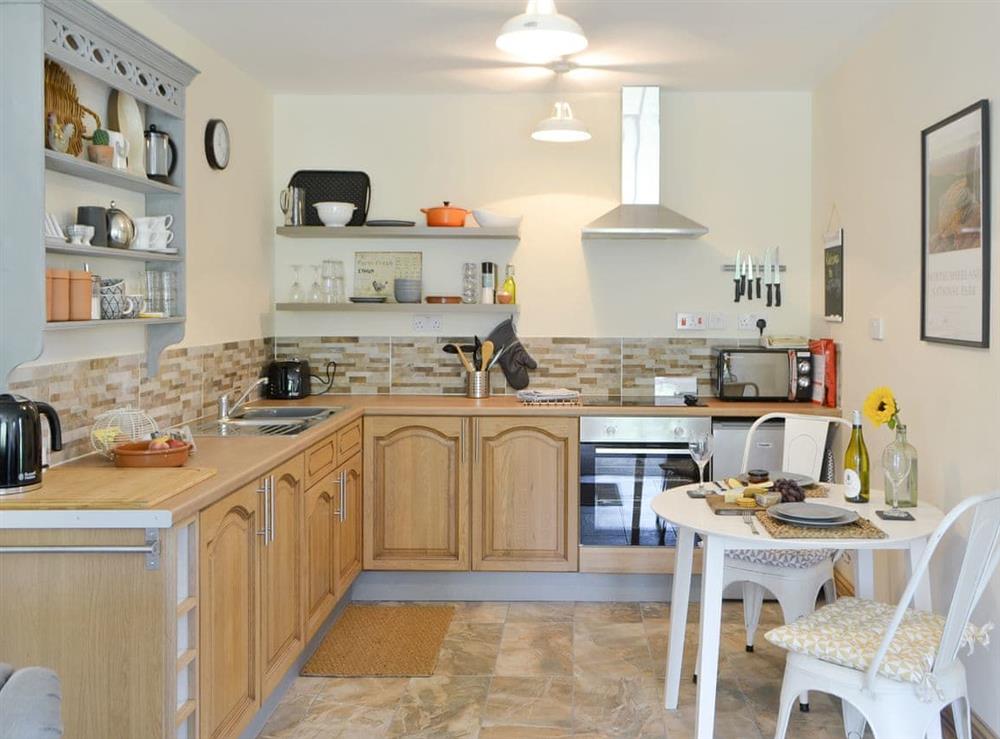 Well-equipped fitted kitchen with dining area at Lapwing Cottage, 