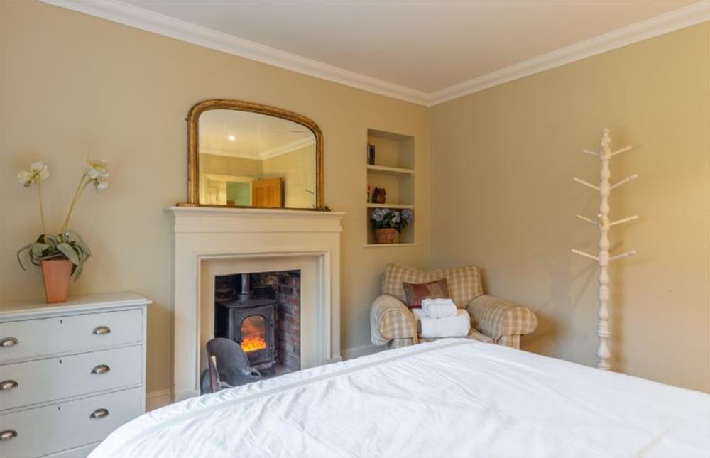 Bedroom with wood burning stove at Higham Place Lodge, Higham