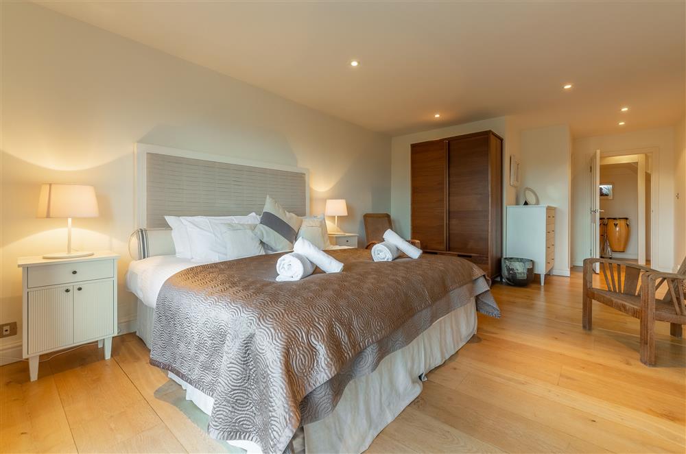 Bedroom with 5’ king-size bed, en-suite bathroom and bi-fold doors to the terrace (photo 2) at Higher Close, Mawgan Porth