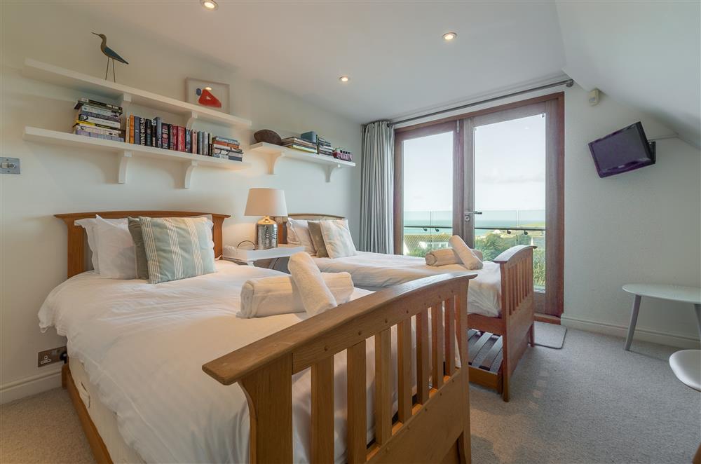 Bedroom with twin single beds, balcony and en-suite shower room (photo 2) at Higher Close, Mawgan Porth