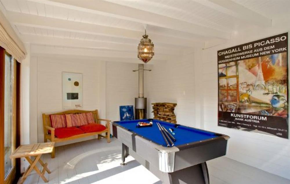 Detached eco games room with pool table and wood burning stove at Higher Close, Mawgan Porth