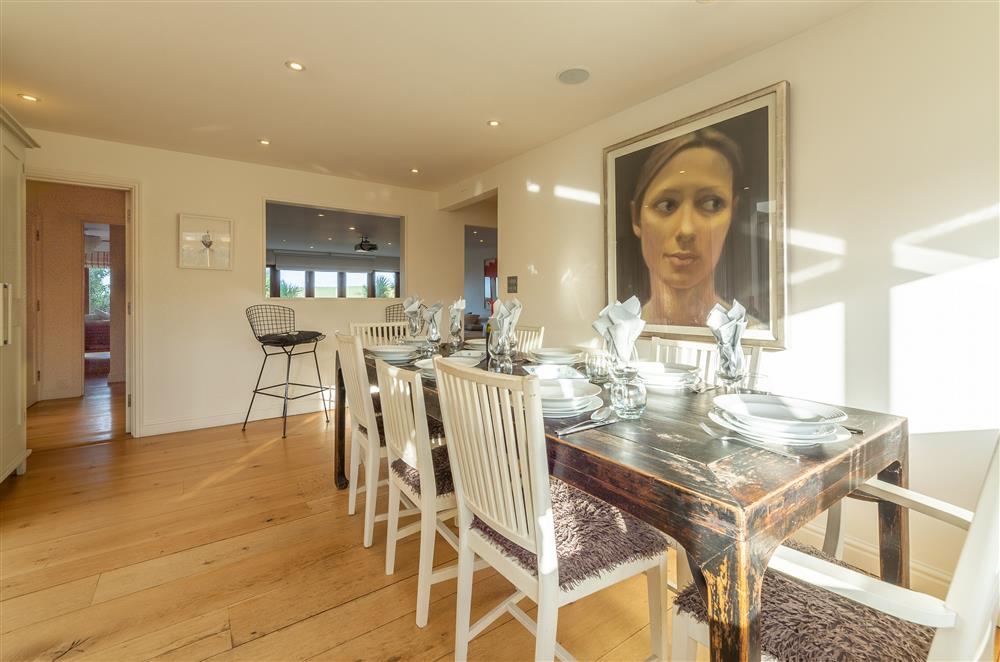 Dining area with solid oak table and seating for eight at Higher Close, Mawgan Porth
