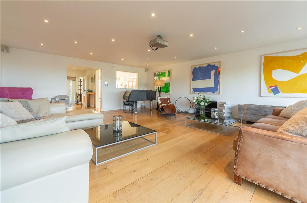 Open-plan living area with large comfortable sofas and a wood burning stove (photo 2) at Higher Close, Mawgan Porth